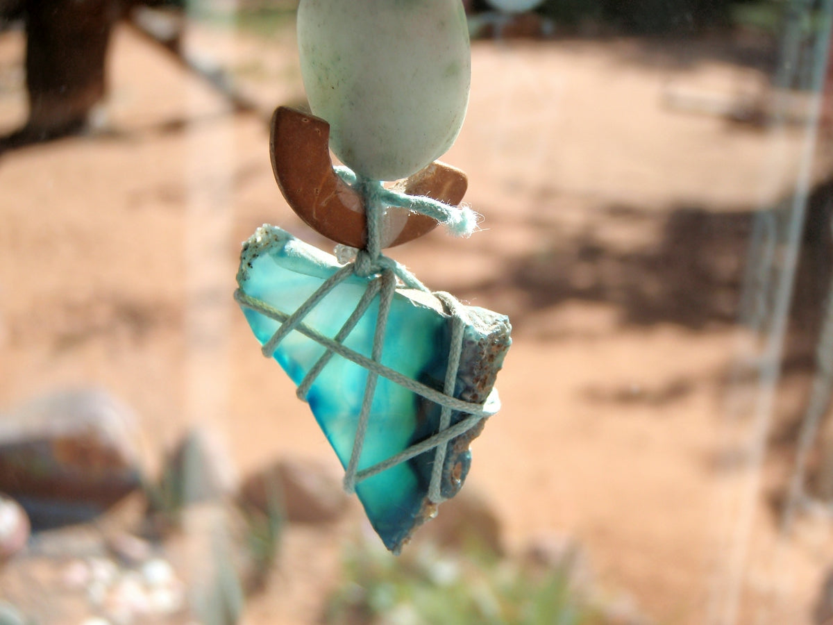Fragment of blue-green stone tied with rope