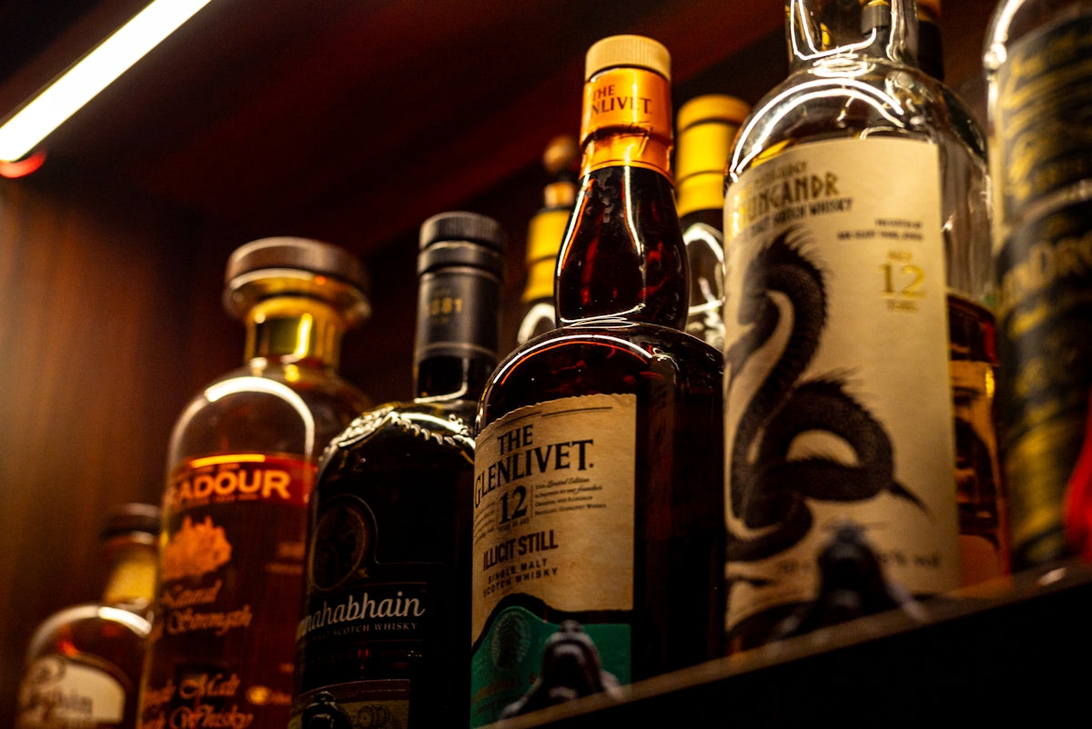 Various bottles of whiskey on a shelf