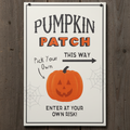 Halloween-themed sign with a pumpkin and text on a wooden background