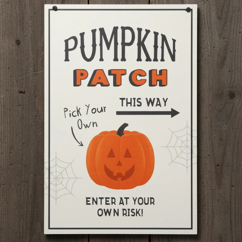 Halloween-themed sign with a pumpkin and text on a wooden background