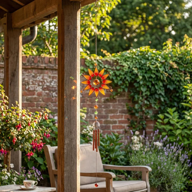 Windchime hanging from veranda post overlooking a backyard during golden hour, with warm light and garden setting.