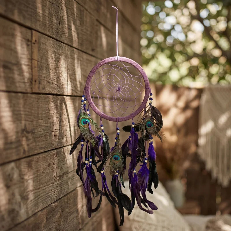 Purple feather dreamcatcher displayed on rustic wooden wall with natural daylight highlighting its intricate peacock feathers and stitching.